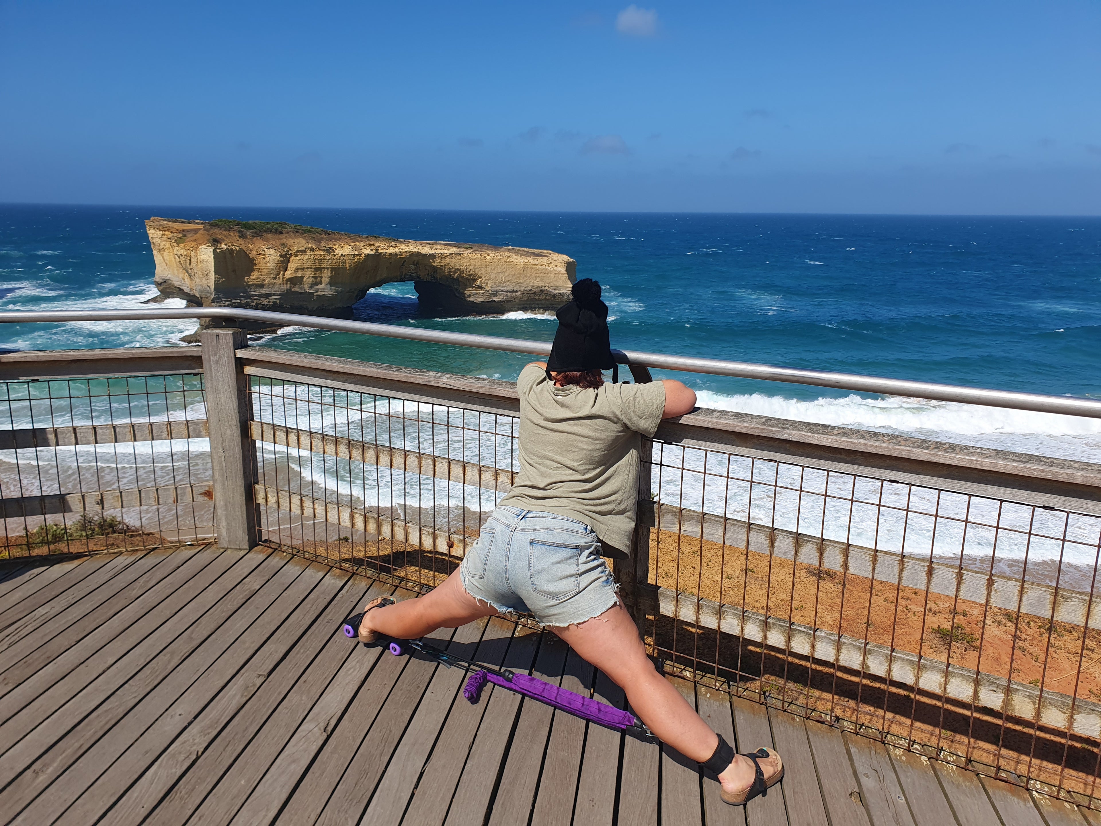 Girl Using Strexi Stretch Machine for Middle Split outdoors with Fence Support