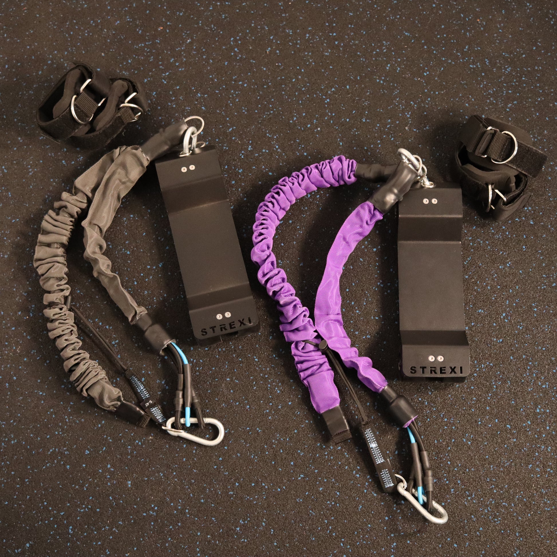 Two Strexi stretching machines. One with purple bands one with grey bands.